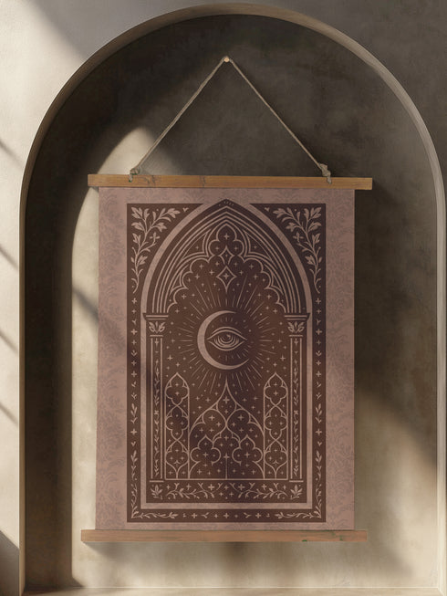 A large, luxurious tapestry in muted mauve and brown, featuring a Gothic arch design. In the center, a crescent moon holds an All-Seeing Eye that radiates light. The design is filled with intricate patterns like quatrefoils and stars, creating a mystical, esoteric feel. The fabric has a subtle damask texture and is hung from wooden dowels. This piece is suitable as spiritual wall art, a witchy altar cloth, or dark academia decor, blending celestial and gothic aesthetics.